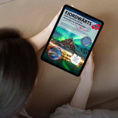 Eine Person hält ein Tablet mit einer bunten Darstellung der Fjorde und Nordlichter.